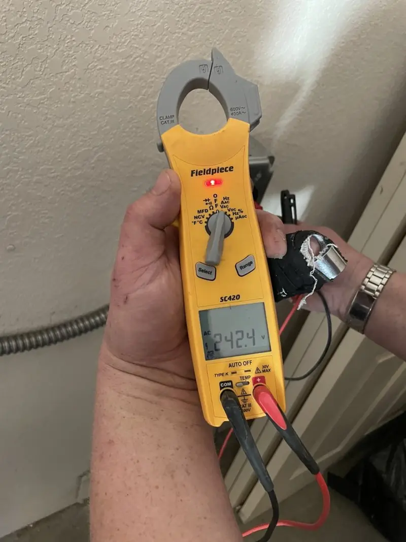 Voltage testing with clamp meter during Recessed Lighting Installation in Gonzales